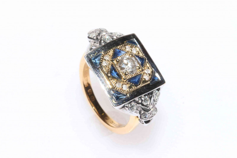 18 carat yellow and white gold sapphire and diamond ring featuring one round brilliant cut diamond, approximate 0.34 carat, eight trillion cut sapphires, approximate total sapphire weight 0.80 carat, and twenty two round brilliant cut diamonds, approximat