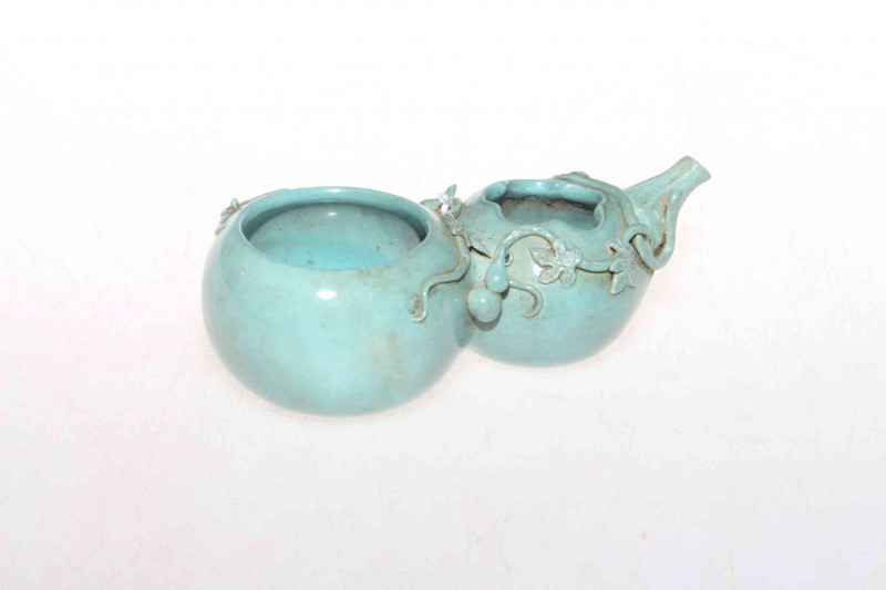 Chinese green glazed brush pot with applied decoration, impressed mark, 14cm length.