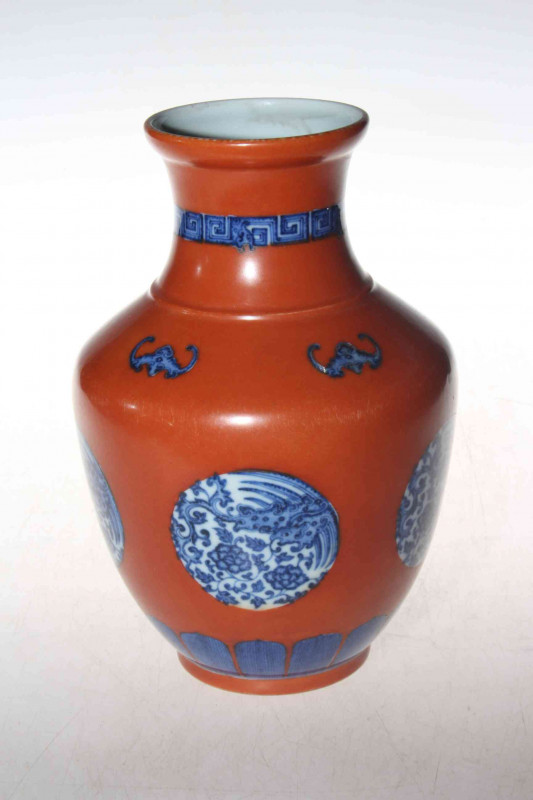 Chinese porcelain vase, having blue and panels on red ground, underglaze blue mark to base, 23cm.