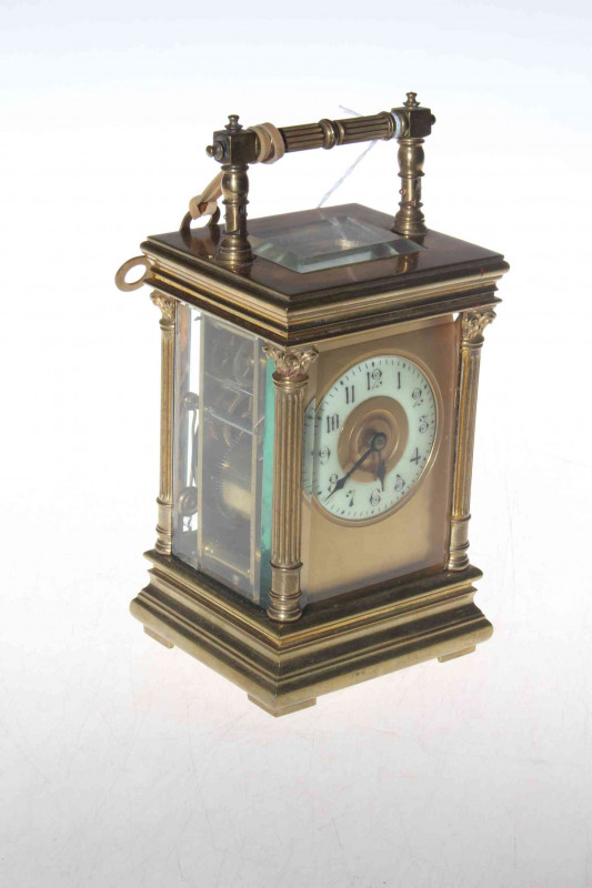 Gilt brass striking carriage clock, the case having corinthian columns and bevelled glass panels, 20cm to handle.