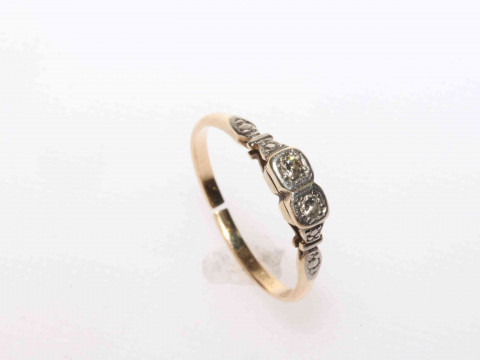 Platinum and 18 carat yellow gold diamond ring featuring two round brilliant...