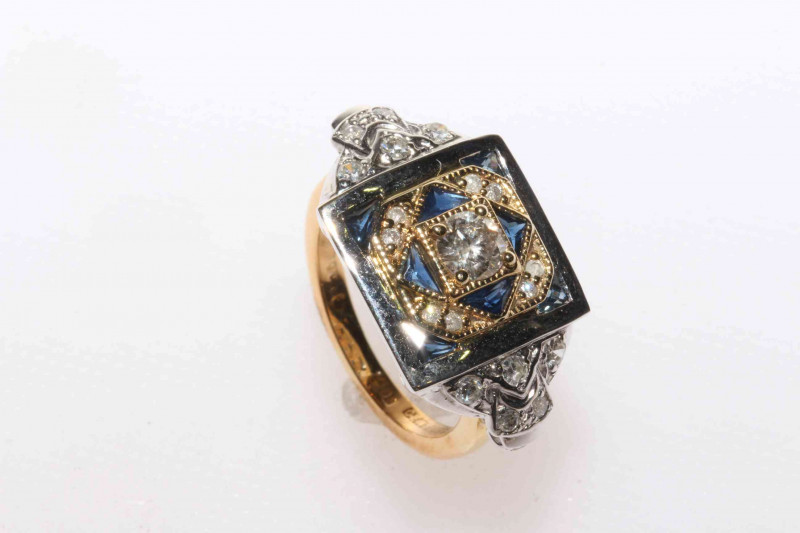 18 carat yellow and white gold sapphire and diamond ring featuring one round brilliant cut diamond, approximate 0.34 carat, eight trillion cut sapphires, approximate total sapphire weight 0.80 carat, and twenty two round brilliant cut diamonds, approximat