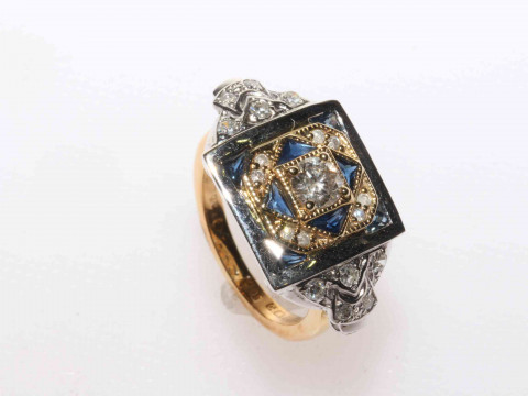 18 carat yellow and white gold sapphire and diamond ring featuring one...