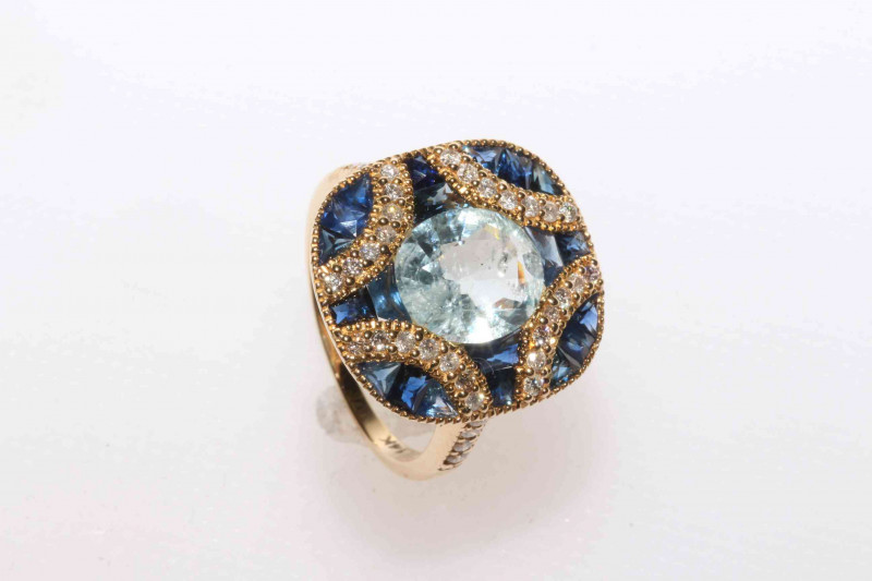 14 carat yellow gold aquamarine, sapphire and diamond ring featuring one oval cut aquamarine, approximate 2.40 carat with twenty two fancy cut sapphires, approximate 2.42 carat and thirty eight round brilliant cut diamonds, approximate total diamond weigh