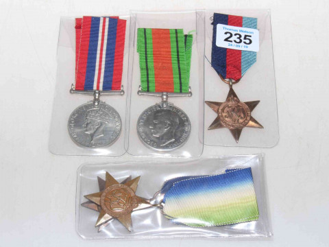 Four WWII medals with ribbons.