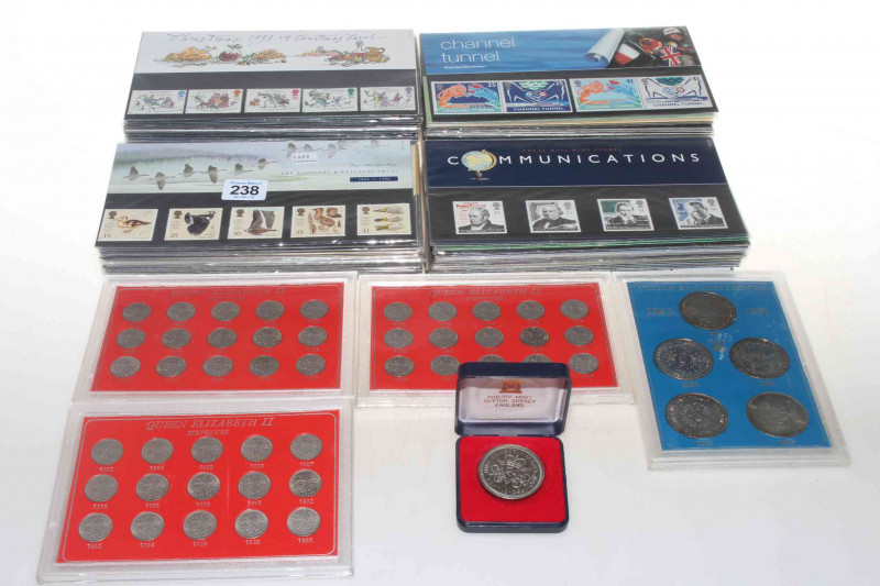 Presentation stamp packs with the face value of £120, together with Elizabeth II coin sets.