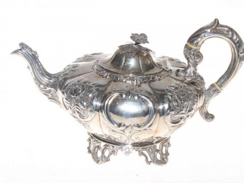 19th Century Irish silver teapot, of lobed form with embossed and chased...