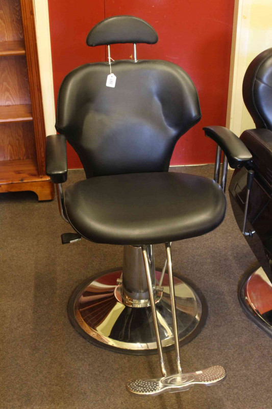 Adjustable swivel barbers chair.