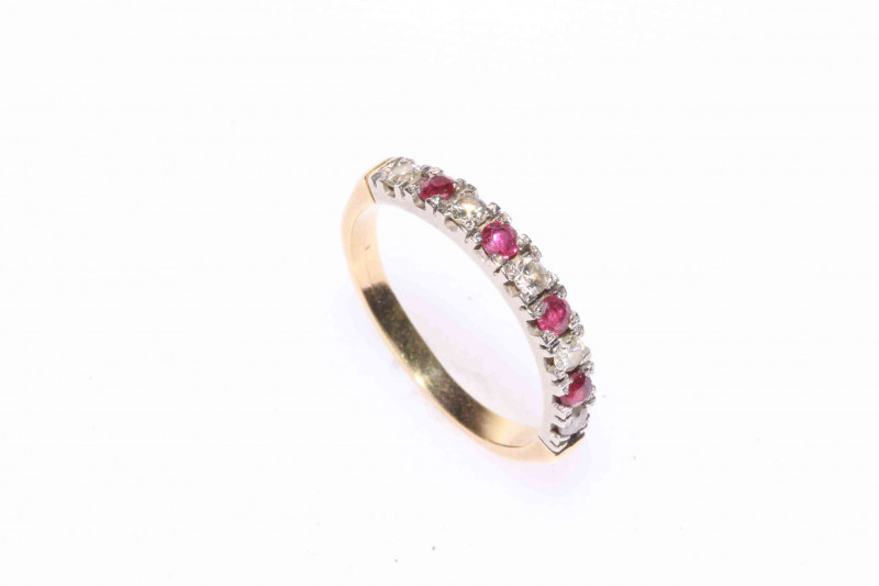 Ruby and diamond nine stone band ring.