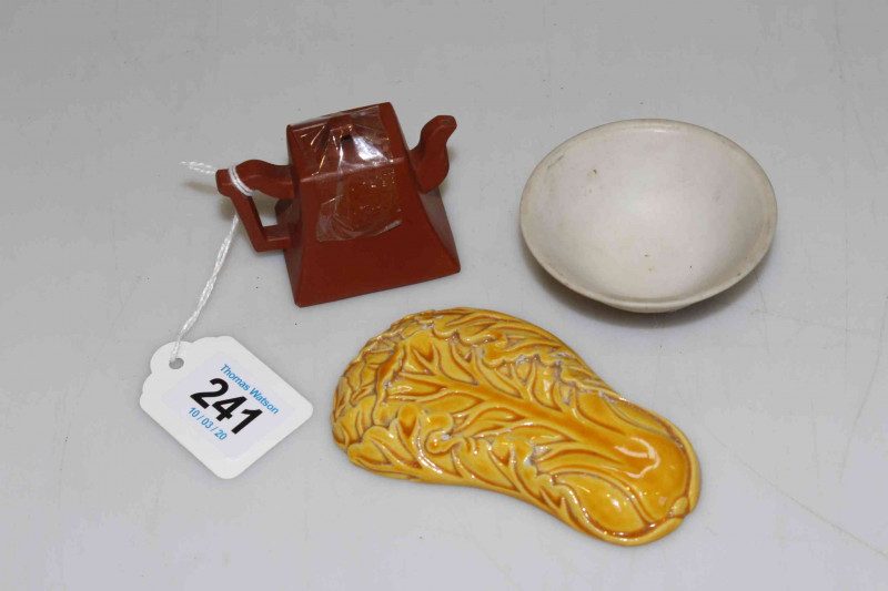 Chinese yellow glazed weight, red ware miniature teapot, and unglazed bowl (3).