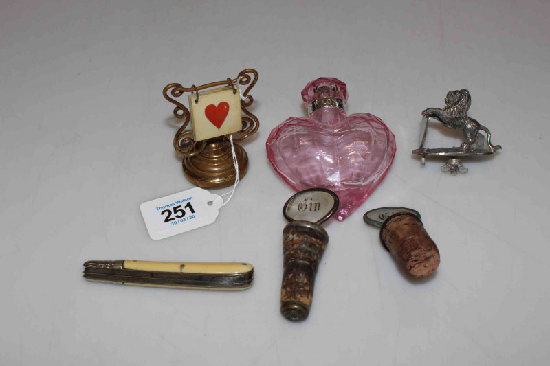 Two bottle stoppers, folding knife, lion handle, scent bottle and whist marker (6).