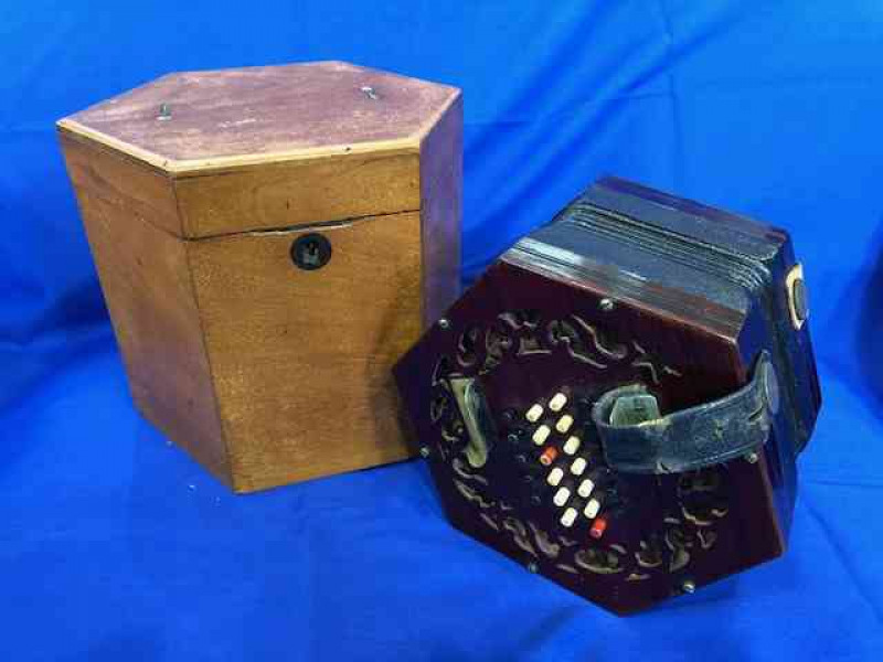 Concertina with 48 buttons and rosewood fretwork ends, in mahogany hexagonal box, probably English, circa 1920.