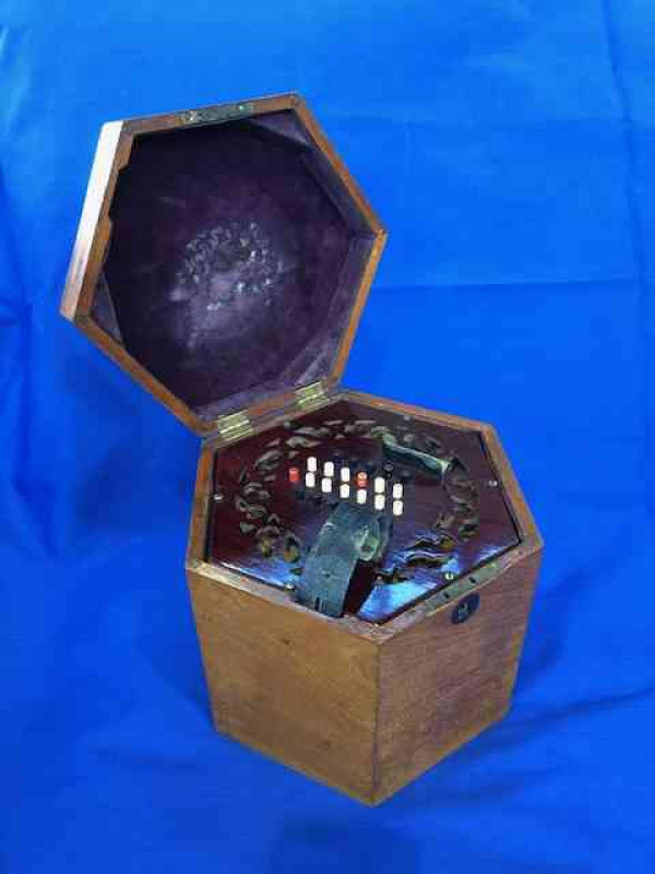 Concertina with 48 buttons and rosewood fretwork ends, in mahogany hexagonal box, probably English, circa 1920.