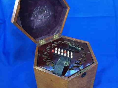 Concertina with 48 buttons and rosewood fretwork ends, in mahogany hexagonal box, probably English, circa 1920. thumbnail