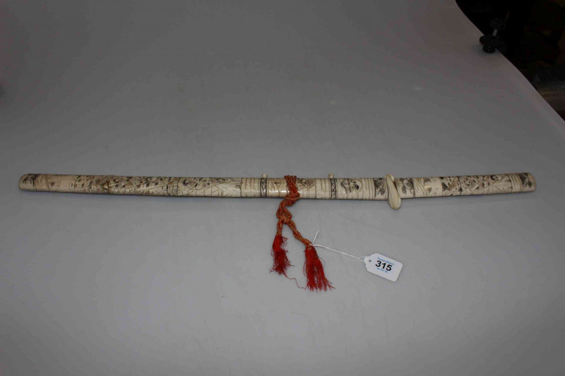 Japanese carved bone sword and scabbard, with profuse figure decoration, overall length 76cm.