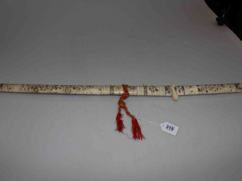Japanese carved bone sword and scabbard, with profuse figure decoration,...