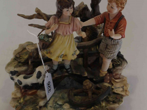Capo di Monte group of two children and a dog crossing a bridge, 24cm.