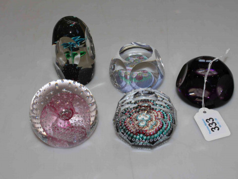 Five glass paperweights.