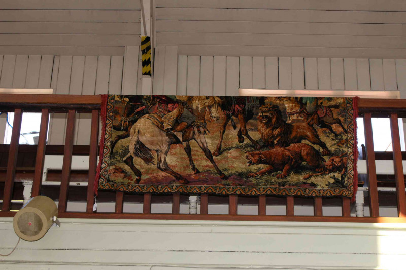 Woven wall hanging depicting lion hunters, 1.65 by 1.20.