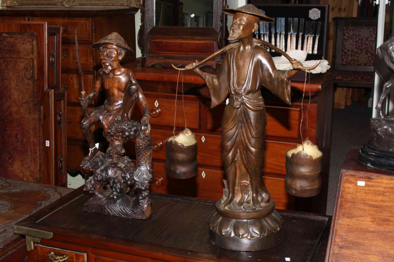 Spelter figure of an Oriental water carrier 70cm high and carved wood figure of Oriental fisherman, 61cm high.