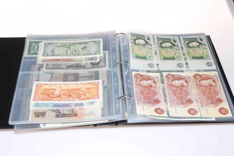 Album of approximately 150 uncirculated worldwide banknotes including Great Britain Elizabeth II one pound and ten shilling notes, Paraguay, Peru, Burma, Myanmar, Bhutan, Bosnia and Herzegovina, Guyana, Greece, etc.