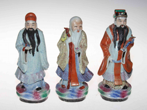 Set of three Chinese polychrome figures of elders, signed inside base,...