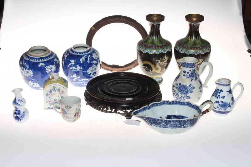 Collection of Chinese pieces comprising two prunus ginger jars, blue and white sauce boat, two jugs and vase, polychrome tea caddy and cup, pair cloisonne vases and two wood stands (12).