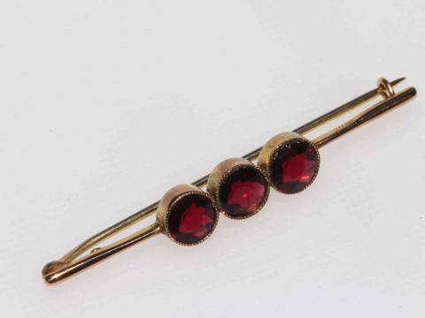 9 carat gold three stone garnet bar brooch.