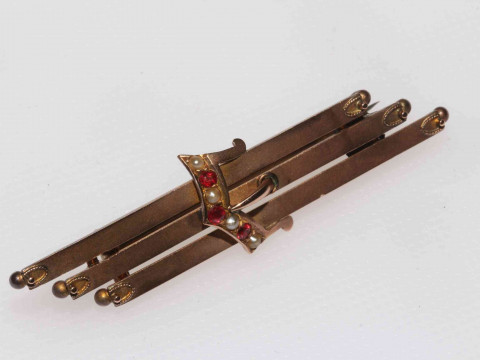 Edwardian 9 carat gold buckle brooch set with garnets and seed pearls.