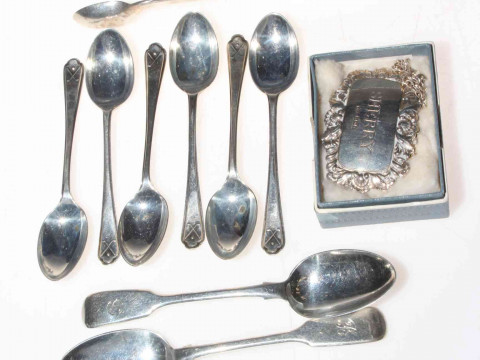 Silver teaspoons, tongs and Sherry label.