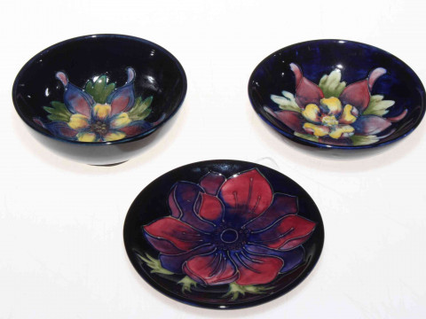 Three small Moorcroft dishes including columbine with warrant label.