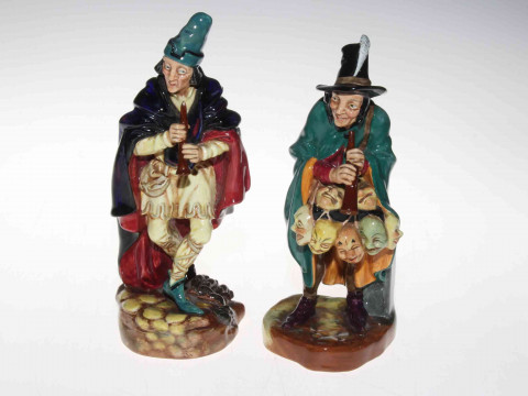 Two Royal Doulton figures, The Mask Sellar and The Pied Piper.