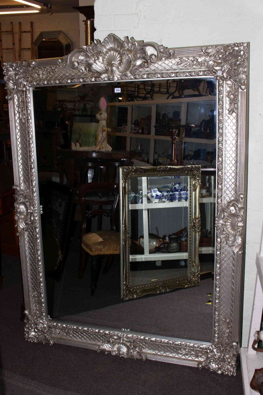 Large ornate silvered frame bevelled wall mirror, 183cm by 134cm overall.