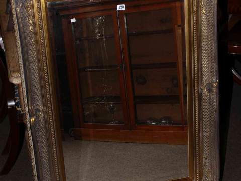 Rectangular swept gilt frame bevelled wall mirror, 118cm by 88cm overall.