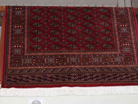 Red ground Bokhara style rug 1.90 by 1.35.
