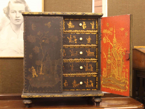 Oriental chinoiserie painted table cabinet having two doors enclosing...