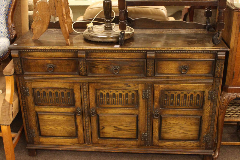 Oak three door sideboard and mahogany two door cocktail cabinet.