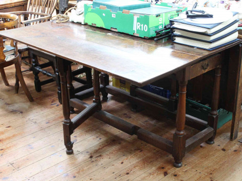 Antique oak two drawer gate leg dining table, 135cm by 77cm (closed).