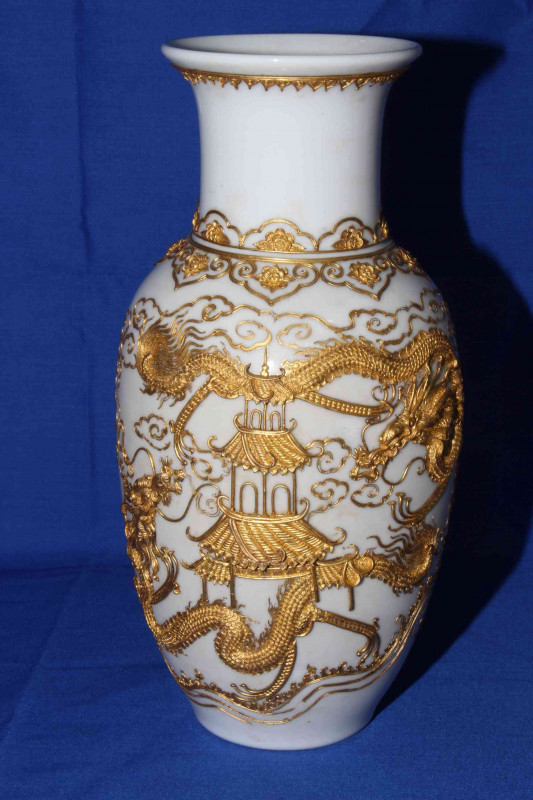Pair Chinese vases having applied gilt decoration of pagoda and dragons on white ground, 30cm.