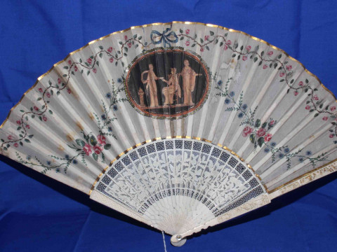 Two antique ivory fans, both painted with panels and foliage. thumbnail