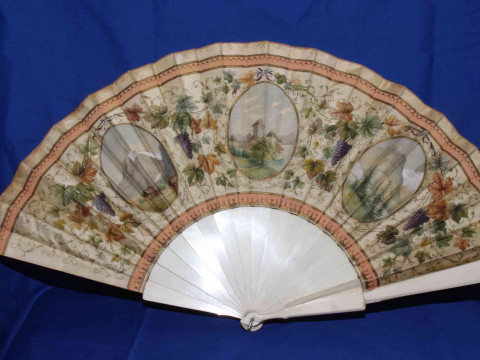 Two antique ivory fans, both painted with panels and foliage. thumbnail