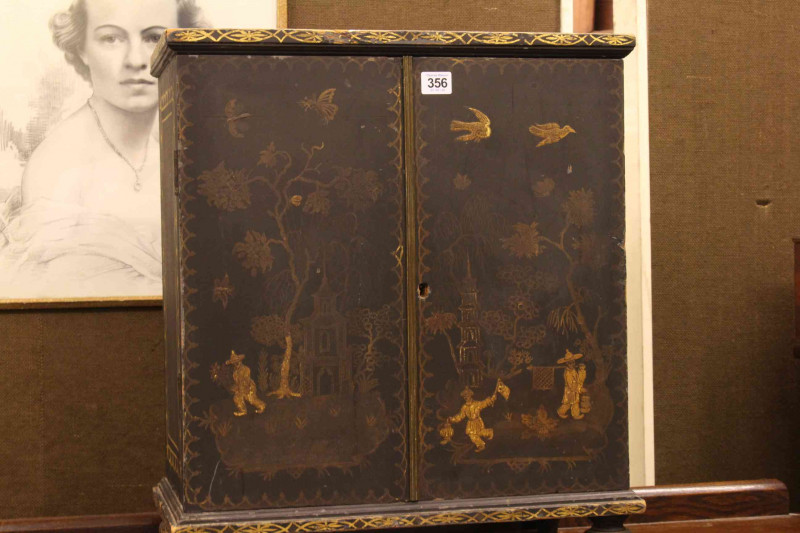 Oriental chinoiserie painted table cabinet having two doors enclosing two short and four long drawers, 56cm by 48cm.