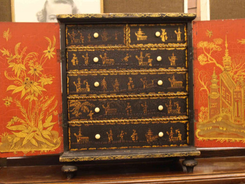 Oriental chinoiserie painted table cabinet having two doors enclosing two short and four long drawers, 56cm by 48cm. thumbnail