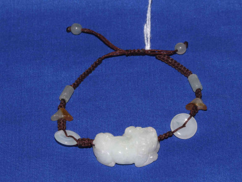 Jade bracelet with carved lion, boxed.