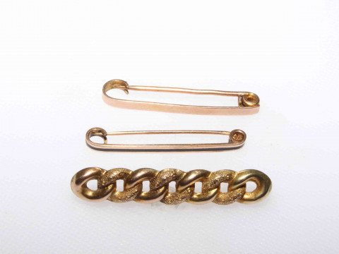 9 carat gold Suffragette brooch and two safety pin brooches.