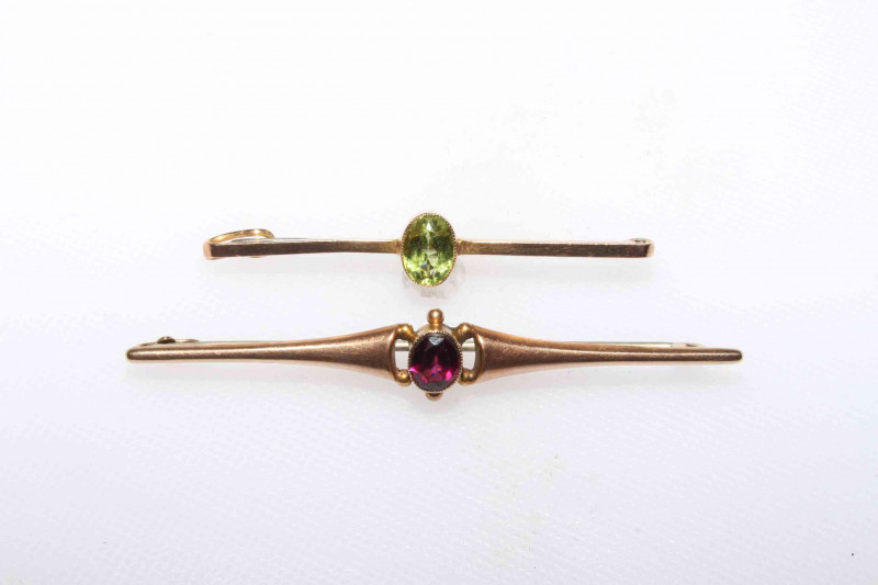 Two 9 carat gold tie pins each set with gemstone.