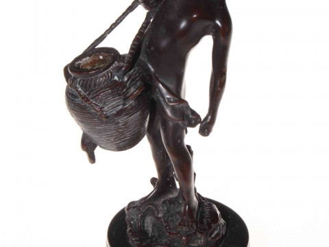 Bronze of child with basket and bird, signed on base, 27cm.