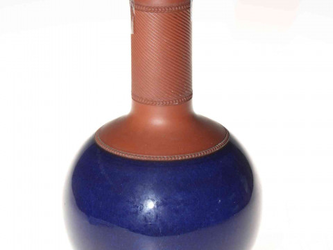 Part glazed red ware bottle vase and cover.