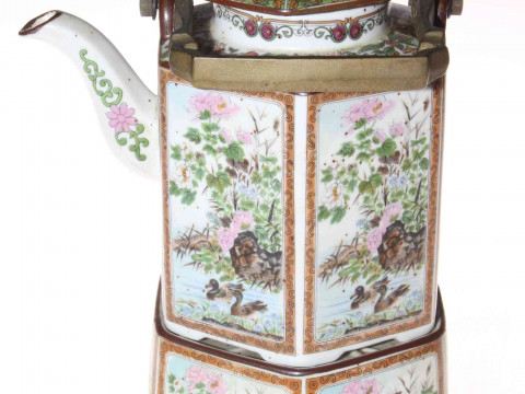 Ornate Chinese teapot and stand.