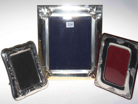 Collection of three silver mounted easel photograph frames, largest with...